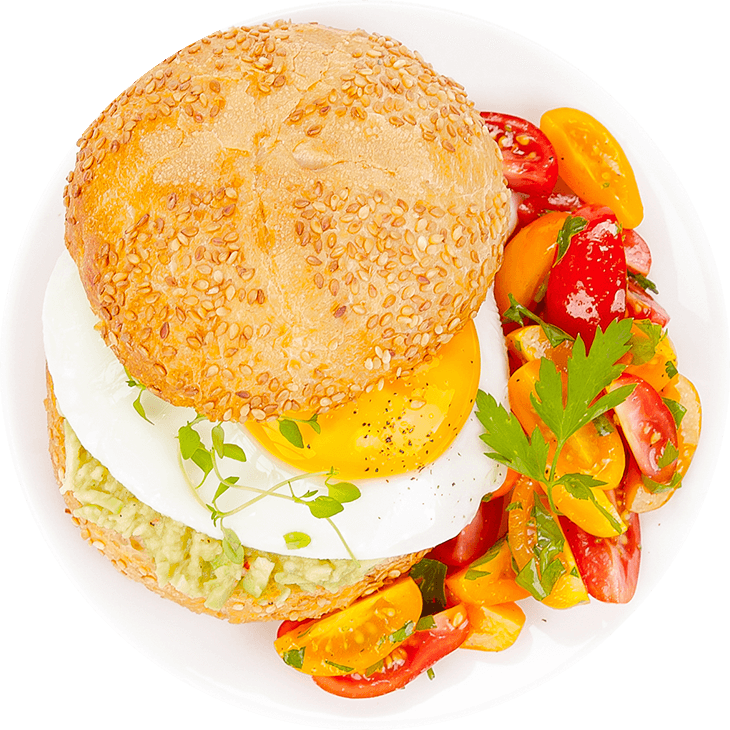 Bread roll with fried egg and avocado paste