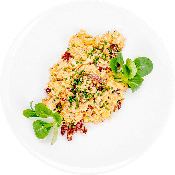 Scrambled eggs with dried tomatoes and chives