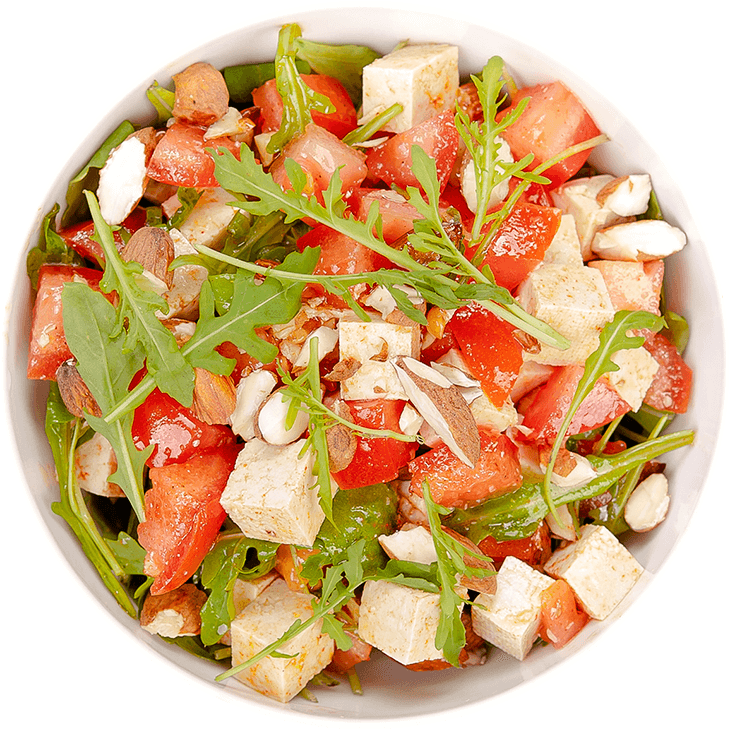 Vegetable salad with tofu, tomatoes, rocket and almonds