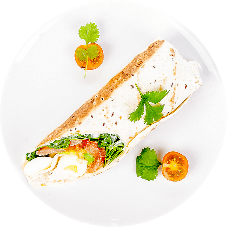 Tortilla wrap with egg, spinach, avocado and tomato